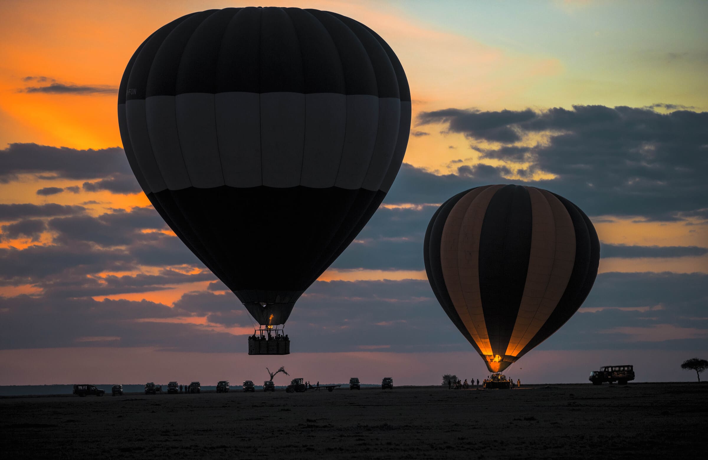 Hot air balloon flying over the Masai Mara at sunrise