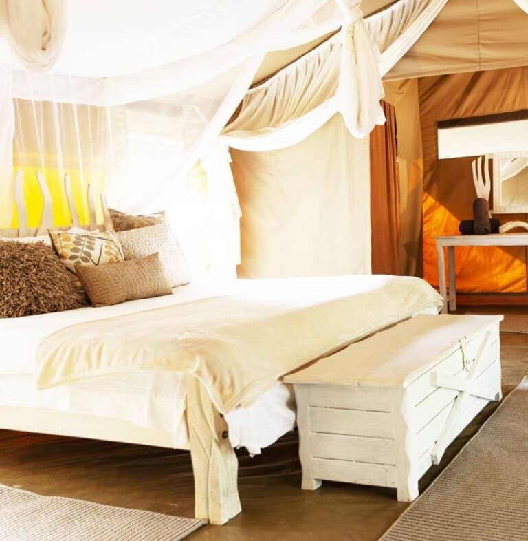 Bright double tent with mosquito nets at Mara Crossing Luxury Camp